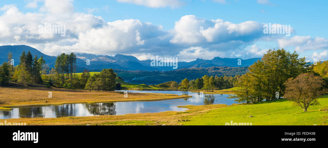 Panorama of Wise Een Tarn on Claife Heights Lake District with Wetherlam Bowfell and the Langdale Pikes on the skyline Stock Photo