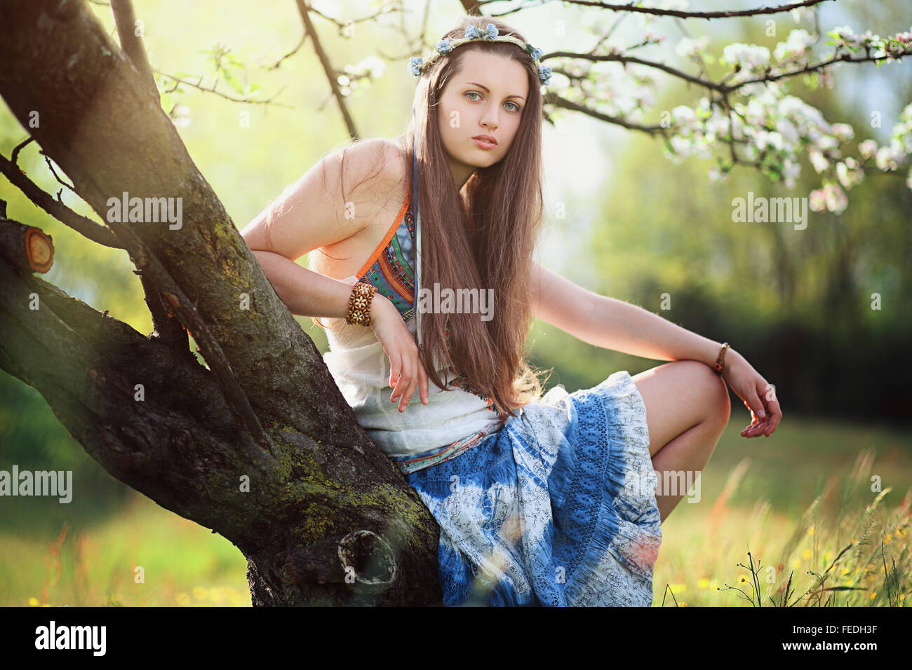 Romantic woman in flower meadow . Hippie and gypsy dress Stock Photo