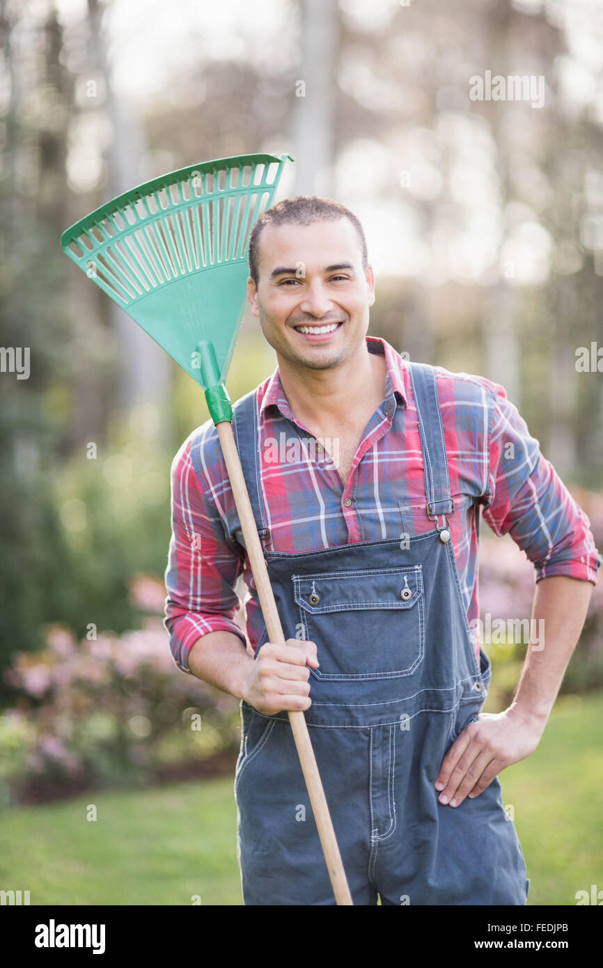 Gardener man holding a rake Stock Photo Alamy