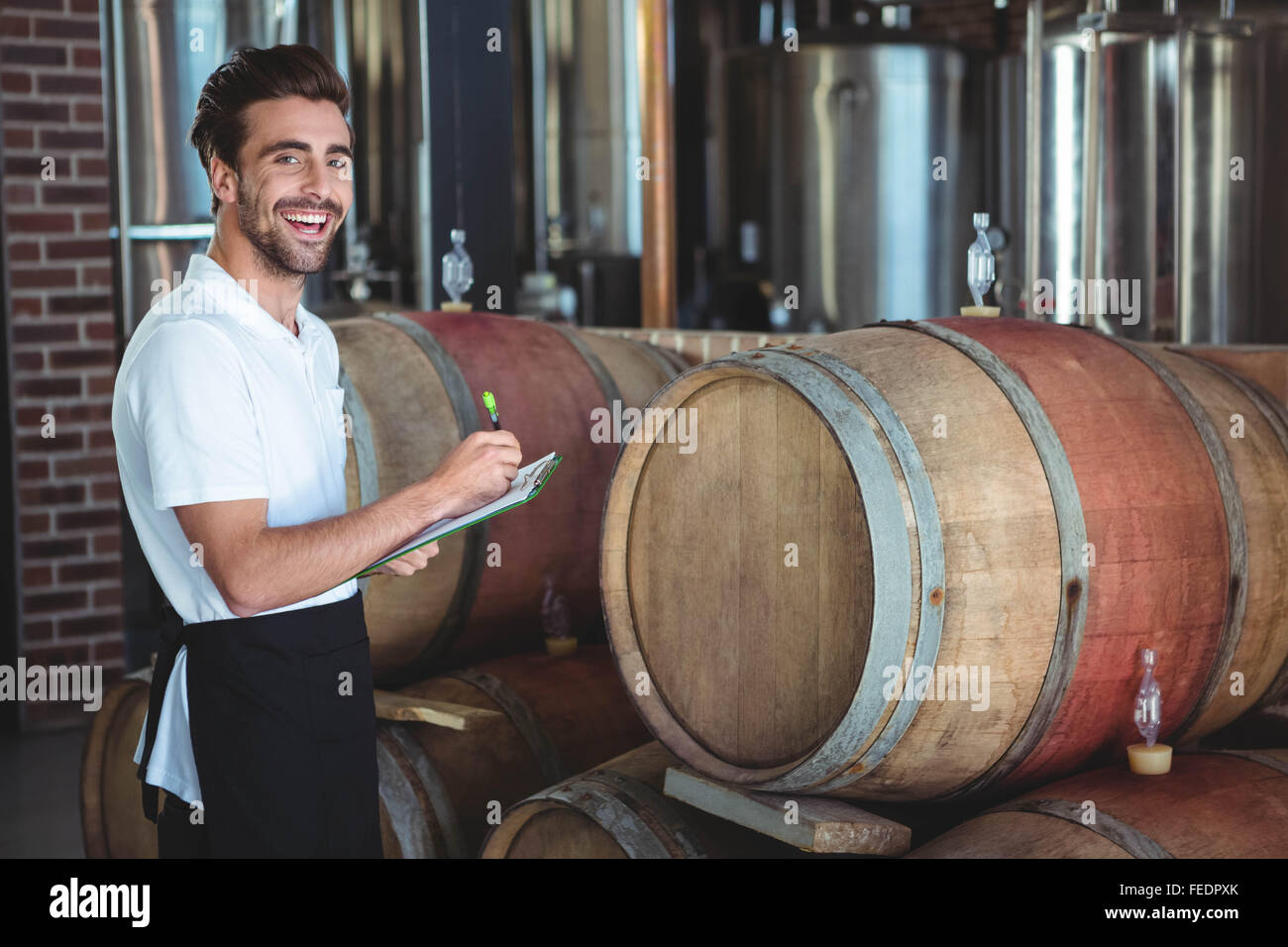 Winemaker taking notes on clipboard Stock Photo