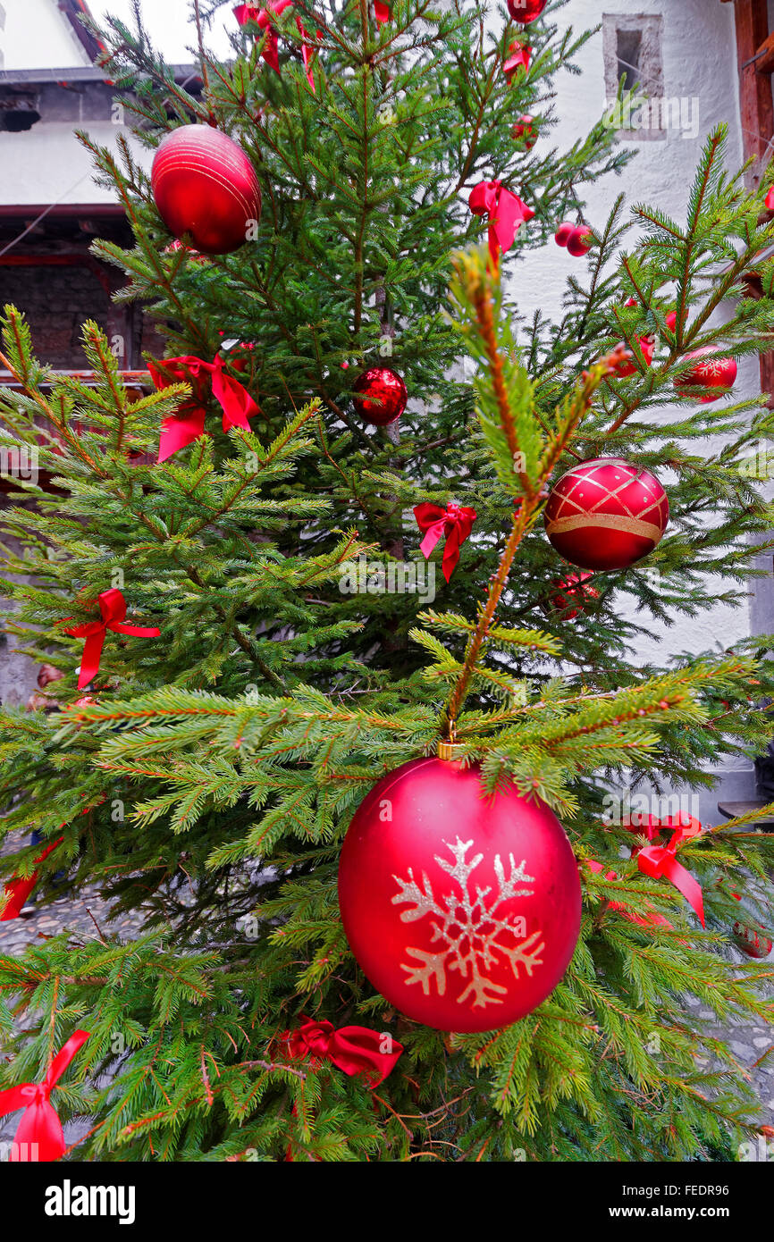 Christmas tree with red balls in the courtyard Stock Photo - Alamy