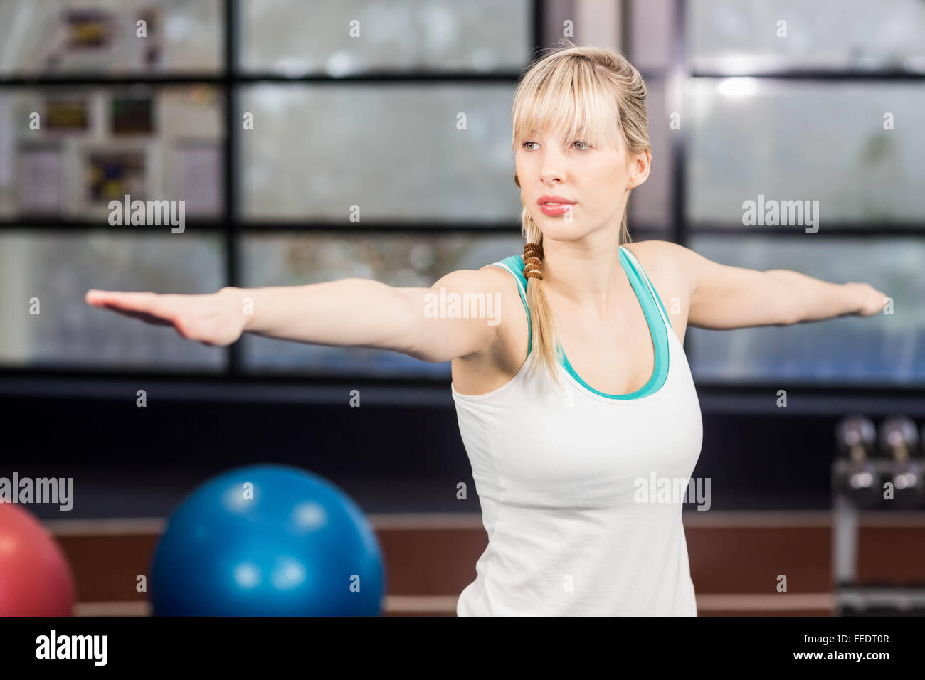 Smiling woman doing yoga exercise Stock Photo - Alamy