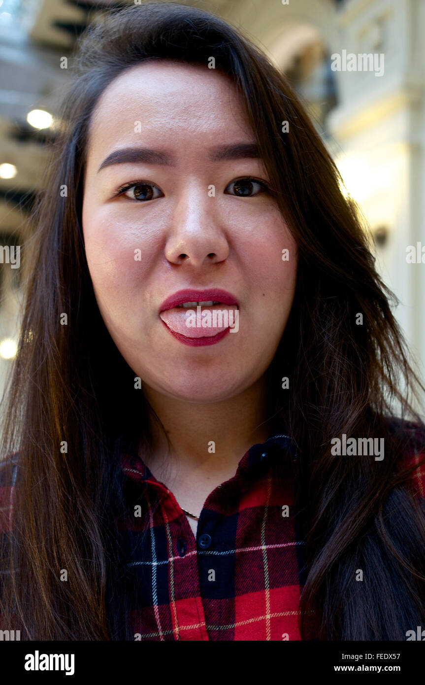 Portrait of a girl making funny face and showing the tongue Stock Photo