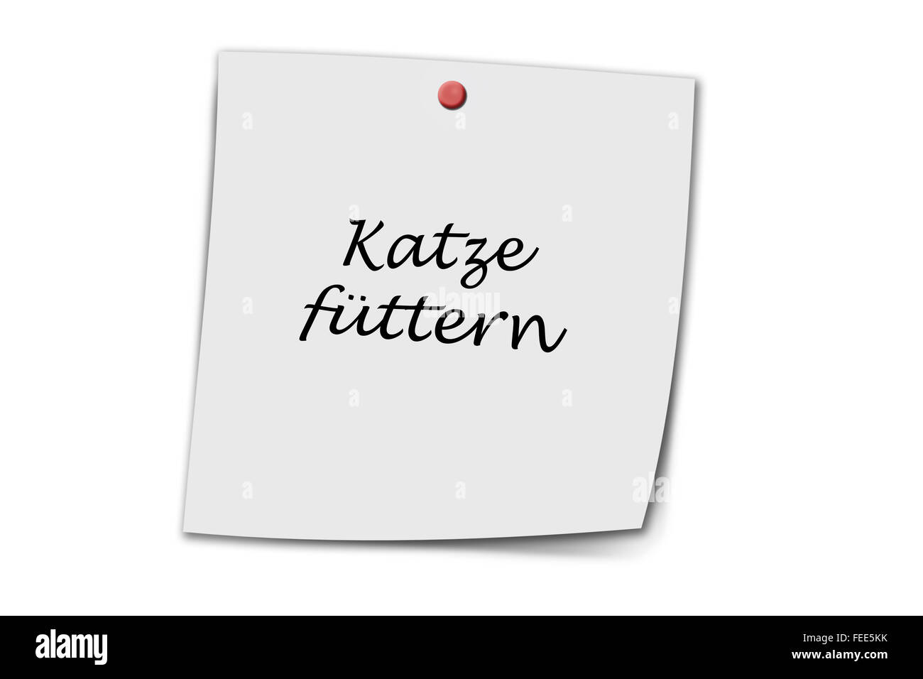 Katze füttern (German feed cat) written on a memo isolated on white Stock Photo