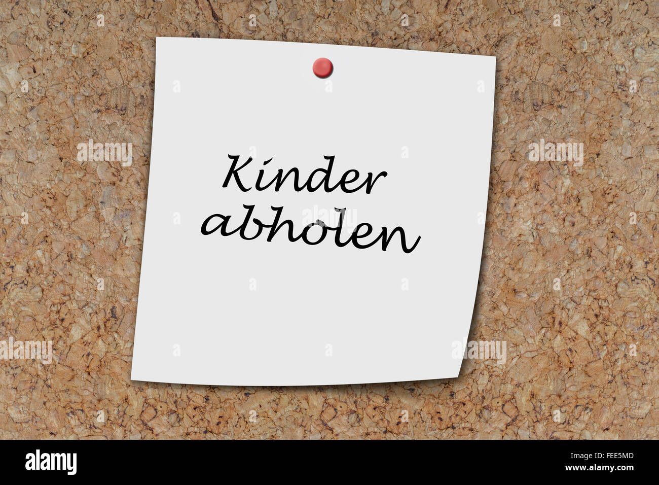Kinder abholen (German pick up kids) written on a memo pined on a cork board Stock Photo