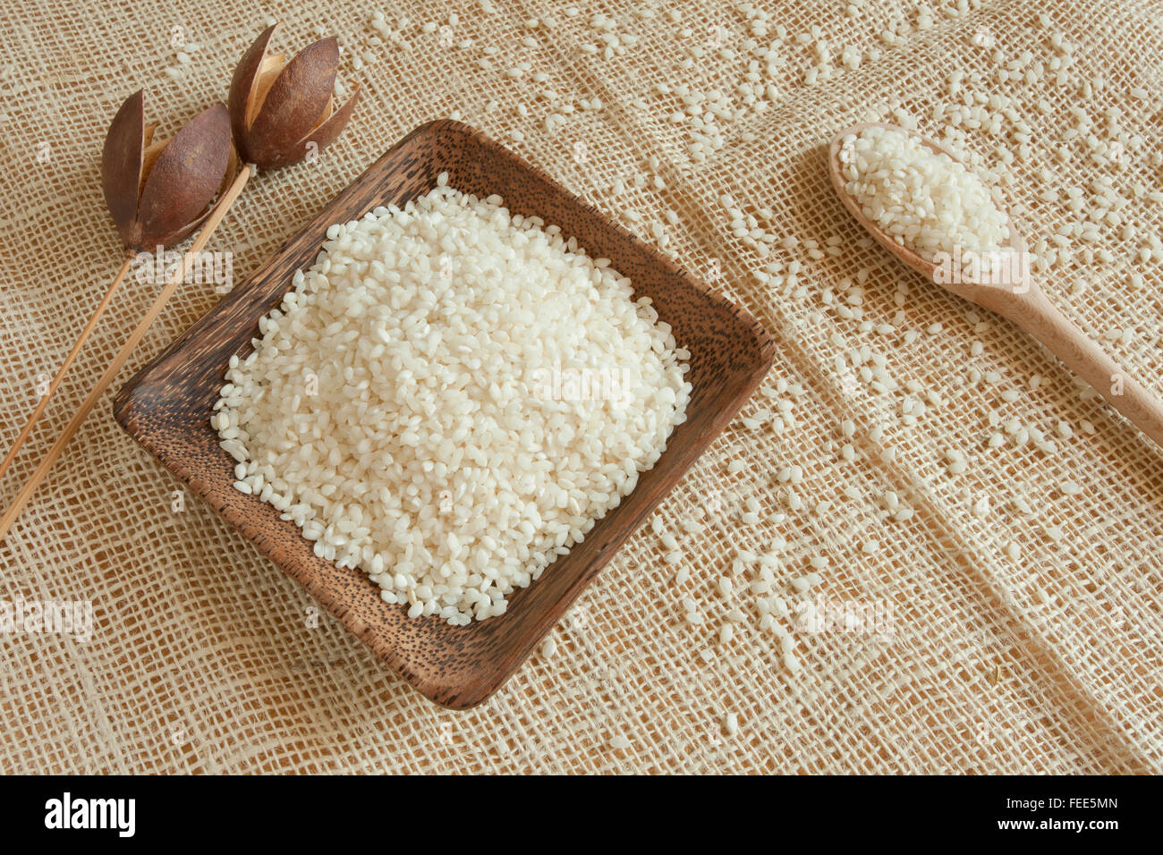 uncooked white rice as natural ingredient inside a wooden up Stock