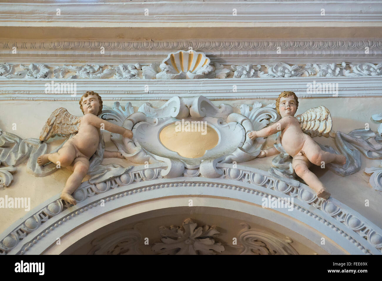 Cherubs, view of a pair of cherubs - or putti - sited above an arch in the duomo (cathedral) in Enna, Sicily. Stock Photo