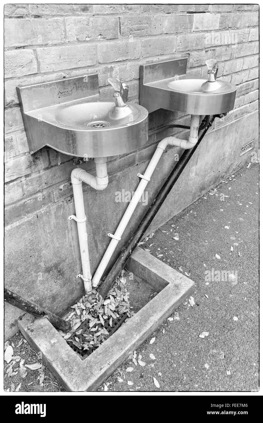 A photo of black and white angular water pipes connected to two