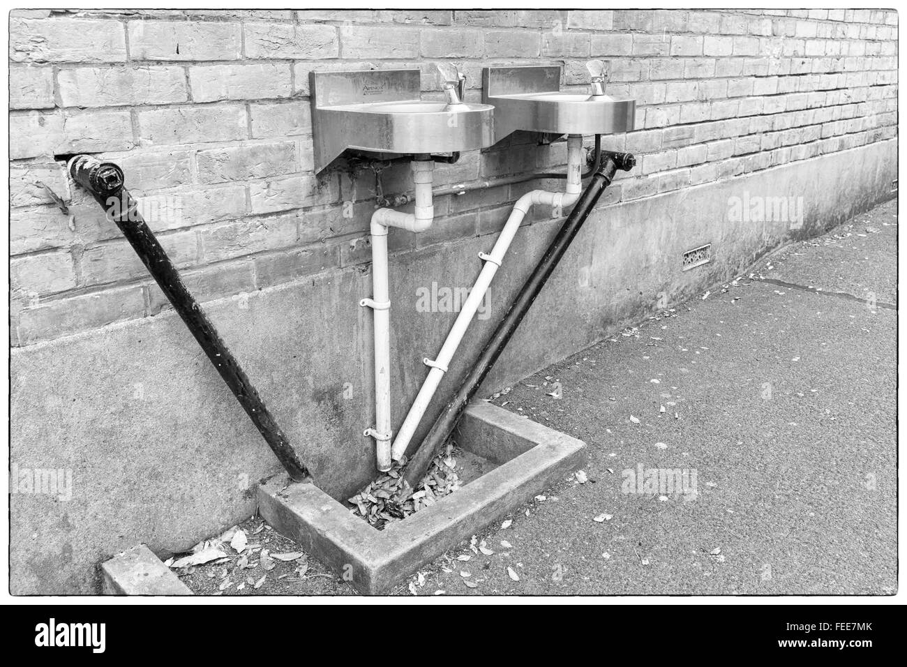 A photo of black and white angular water pipes connected to two