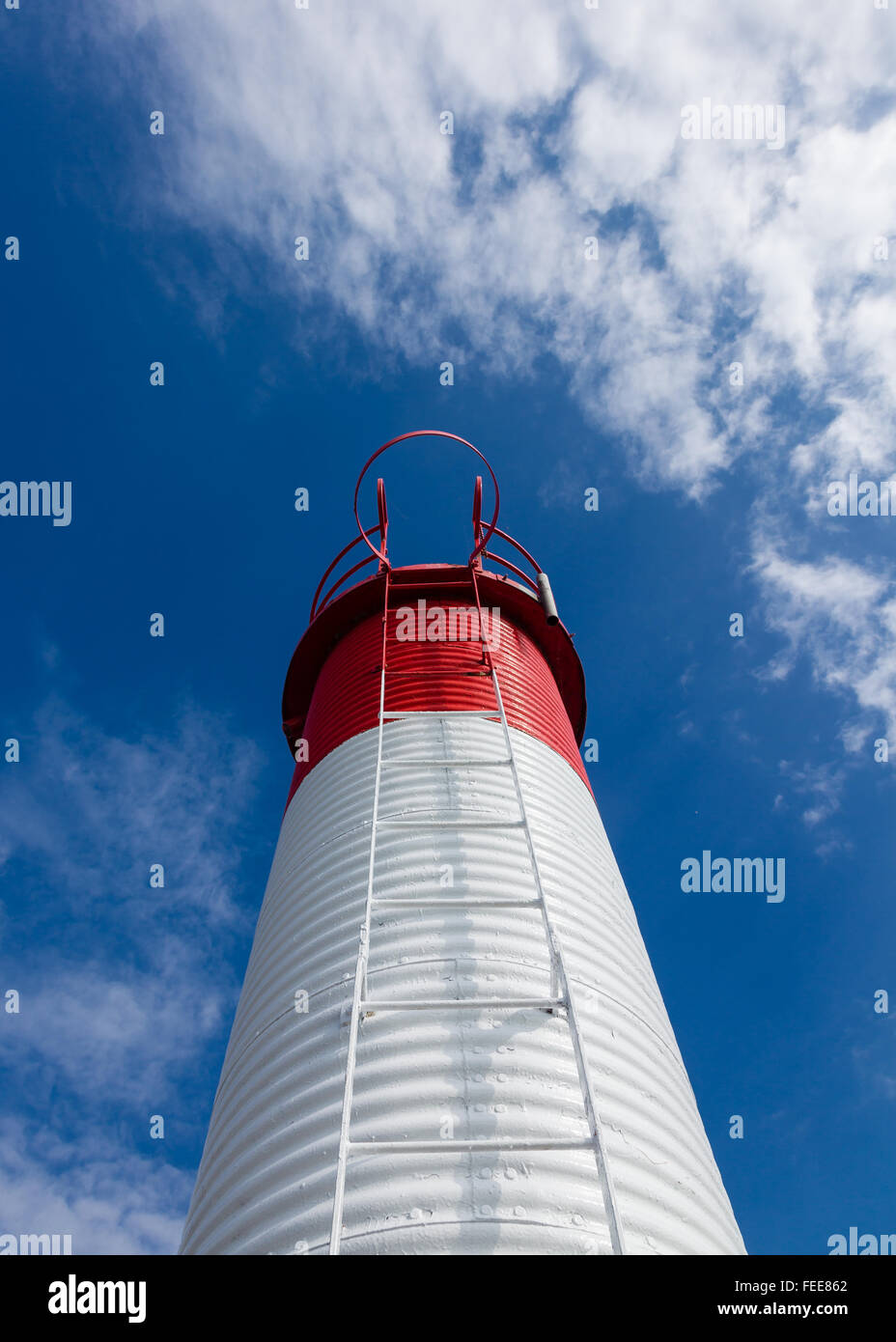 Red and white navigation marker with ladder at a harbor on Lake Ontario. Stock Photo