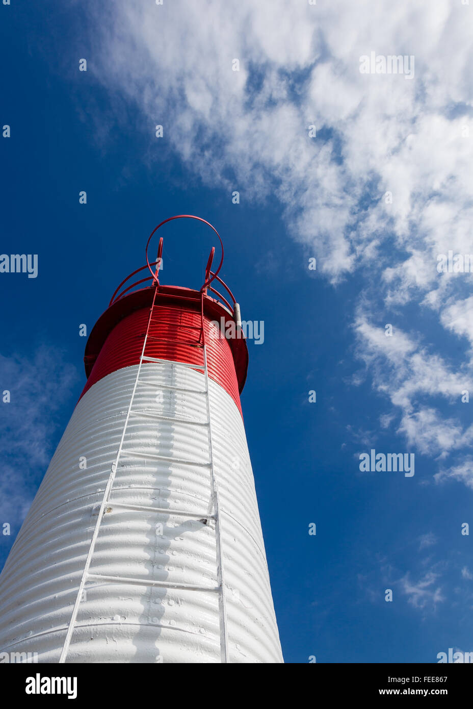 Red and white navigation marker with ladder at a harbor on Lake Ontario. Stock Photo
