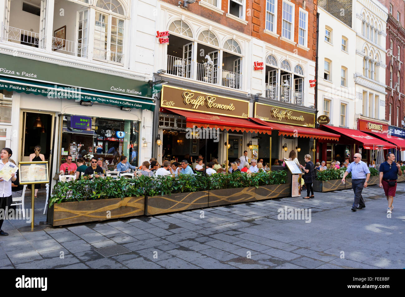 A street in the popular Leicester Square district with bars, restaurants and cafés, London, United Kingdom. Stock Photo