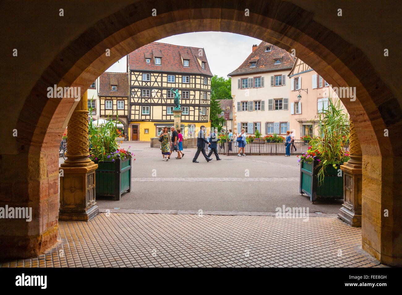 View of the Ancienne square through the arch  or passage of the Koifhus at the old town, Colmar, Alsace, Haut-Rhin, France Stock Photo