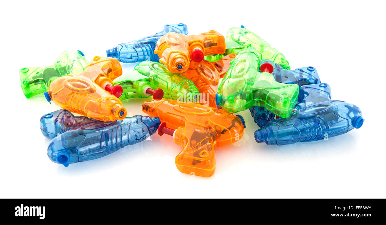 Pile of colorful plastic water pistols on a white background Stock Photo