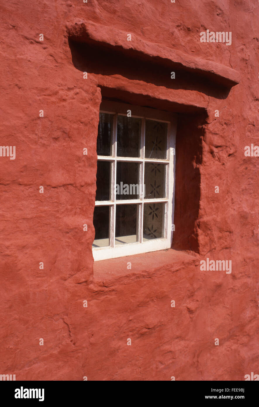 Kennixton Farmhouse window surrounded by red painted wall Reconstructed farmhouse at National History Museum Cardiff Wales UK Stock Photo