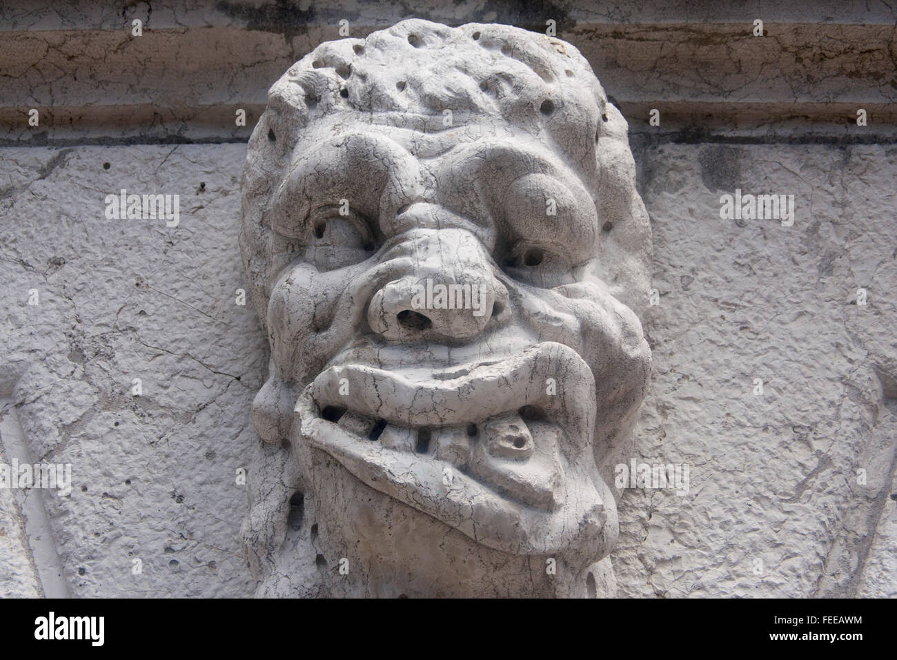 Grotesque gargoyle carving of male man's head on exterior of Santa Maria Formosa church Castello sestier Venice Veneto Italy Stock Photo