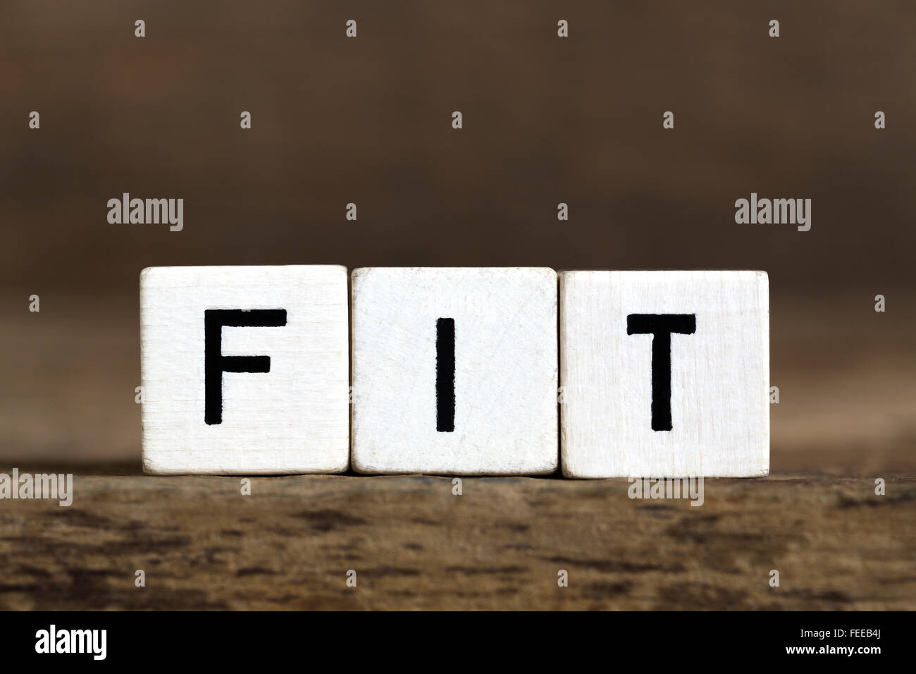 The word fit written in cubes on a wooden background Stock Photo