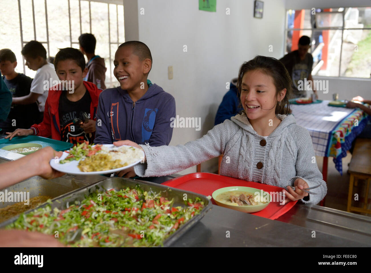 Girl receiving food at the food counter of a cafeteria, social project, Bogota, Colombia Stock Photo
