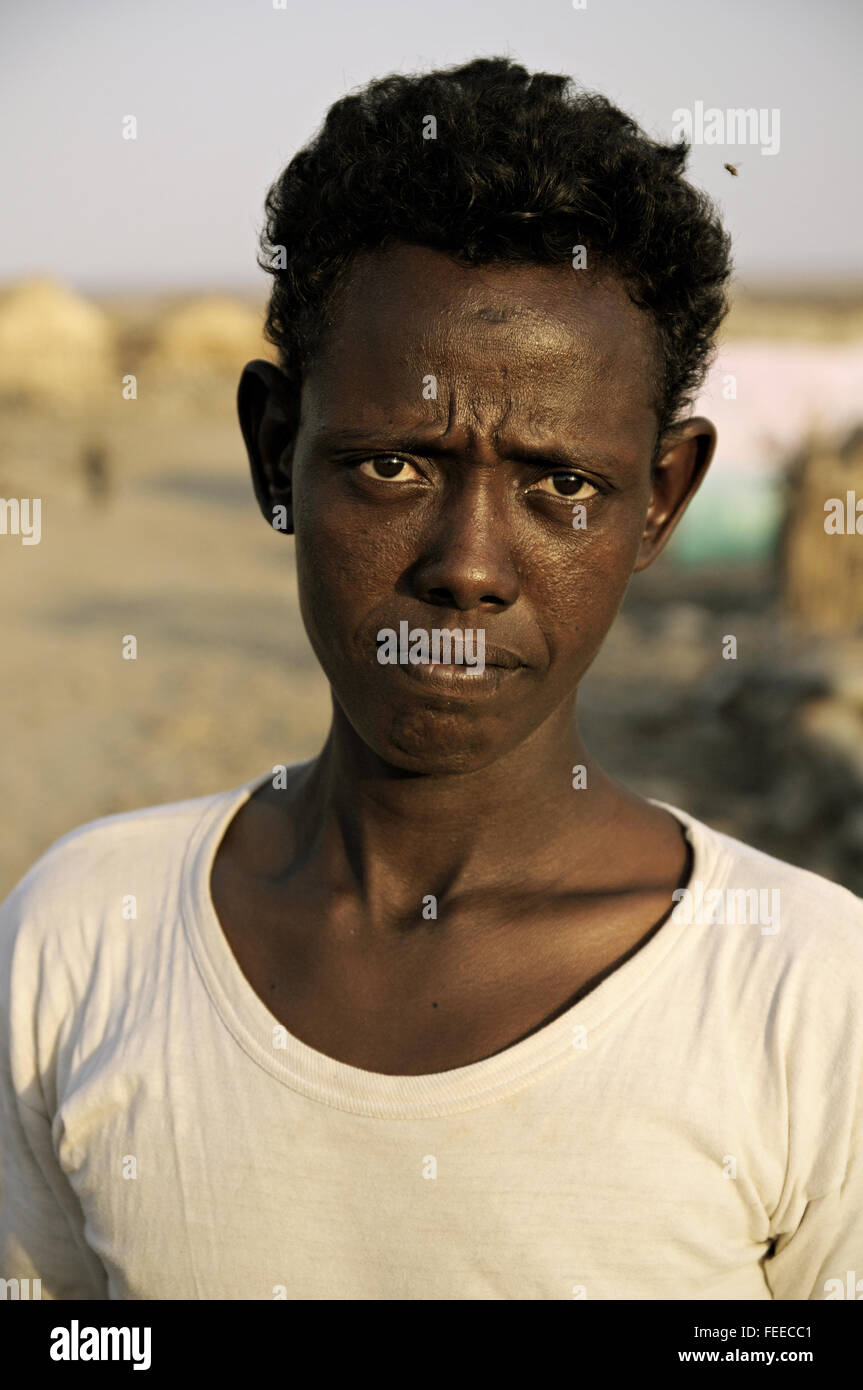 Head portrait of a man with a white t-shirt in the village of Ahmed Ela, Danakil depression, Afar Region, Ethiopia Stock Photo