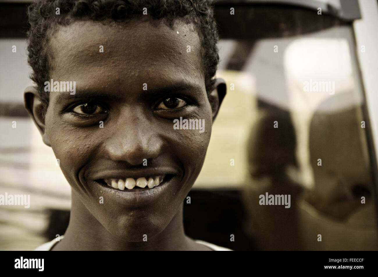 Young Afar man with sharp teeth smiling, Ahmed Ela, Danakil depression, Afar Region, Ethiopia Stock Photo
