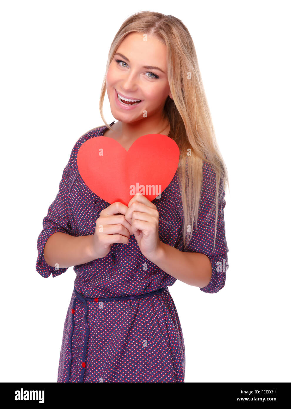 Cute cheerful girl with red paper heart in hands isolated on white background, symbol of health and love Stock Photo