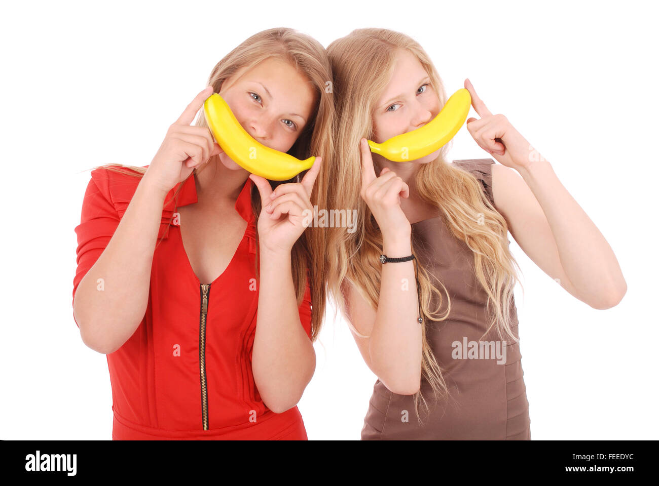 Two beautiful young Caucasians girl with banana smile Stock Photo