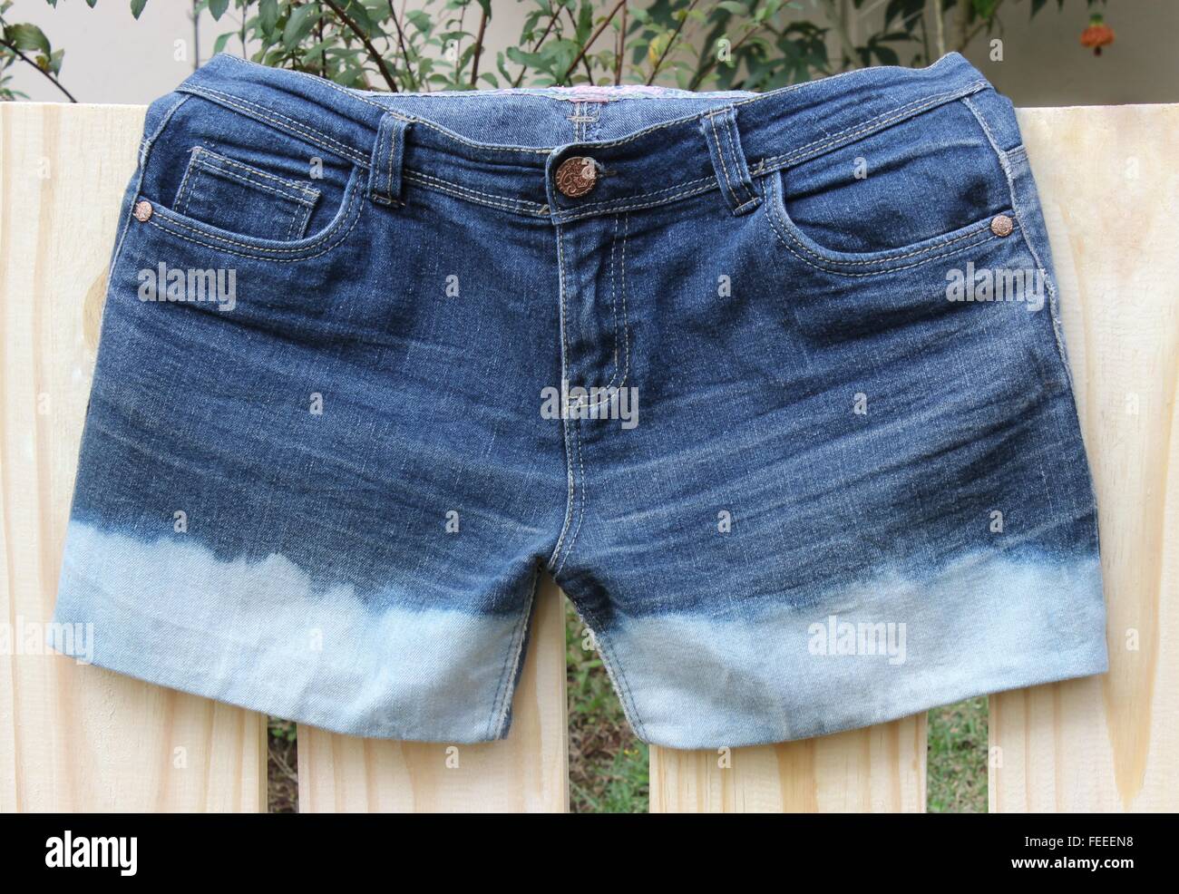 Short jeans after applying bleach, presented discoloration. Stock Photo