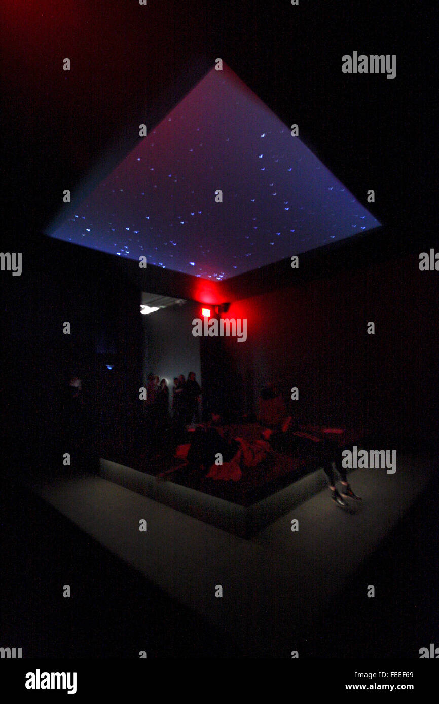 Visitors lying on a bed like platform, while watching images of the skies above Yeman, Somalia and Pakistan overhead, as part of the installation of Astro Noise, the first solo exhibit by artist Laura Poitras at the Whitney Museum of American Art in New York City on February 3, 2016.  Later in the exhibit thermal images captured while people lay in this room, are displayed.  Poitras, a filmmaker, artist and journalist best known for helping to break the Edward Snowden story, created the exhibition as an immersive multimedia experience examining topics such as mass surveillance, the war on terr Stock Photo
