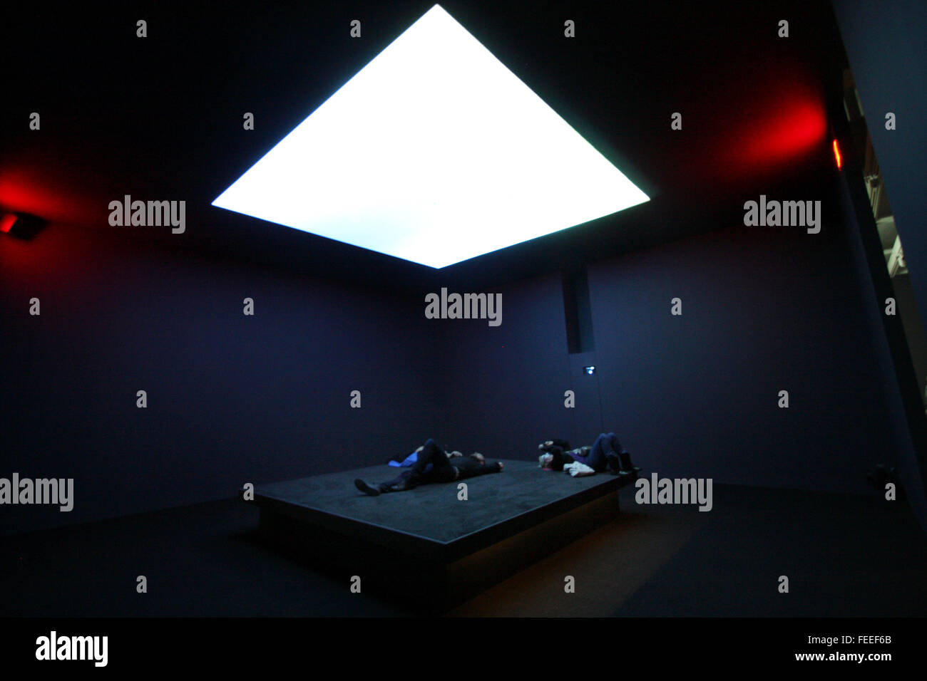 Visitors lying on a bed like platform, while watching images of the skies above Yeman, Somalia and Pakistan overhead, as part of the installation of Astro Noise, the first solo exhibit by artist Laura Poitras at the Whitney Museum of American Art in New York City on February 3, 2016.  Later in the exhibit thermal images captured while people lay in this room, are displayed.  Poitras, a filmmaker, artist and journalist best known for helping to break the Edward Snowden story, created the exhibition as an immersive multimedia experience examining topics such as mass surveillance, the war on terr Stock Photo