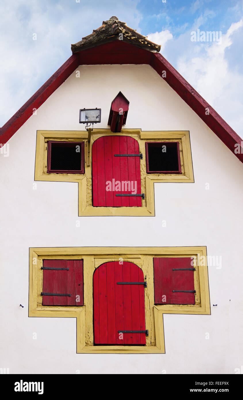 Fragment of facade of old medieval house with distinctive red wooden shutters in Rothenburg ob der Tauber, Bayern, Germany Stock Photo