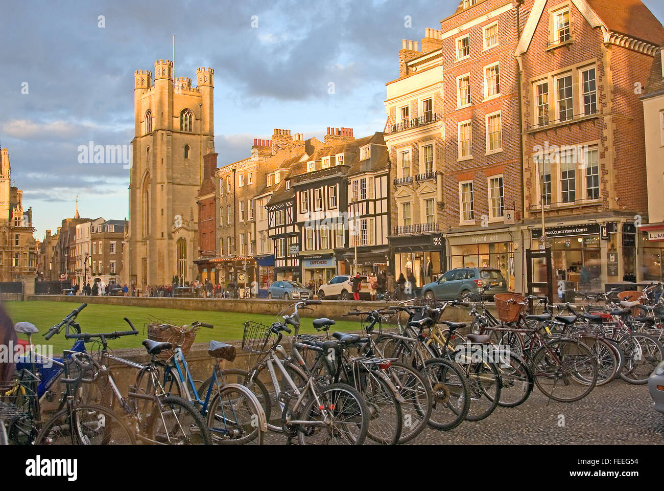 Streetscene in Cambridge city centre with bicycles parked on racks outside a college entrance. Stock Photo