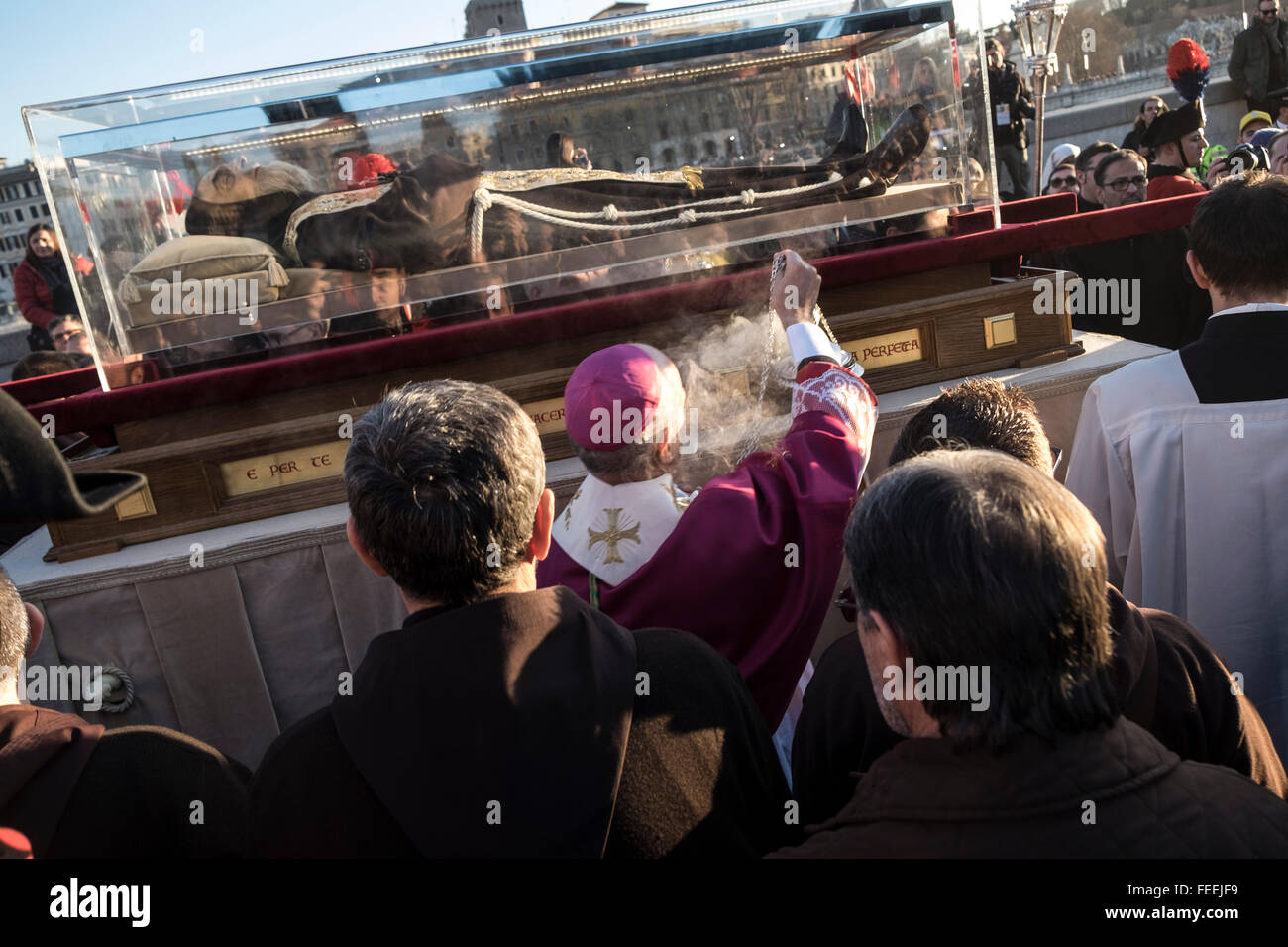 Rome, Italy. 05th Feb, 2016. Italian Archbishop Rino Fisichella spreads incense during over the crystal coffin containing the exhumed body of mystic saint Padre Pio. The body of one of the most popular Roman Catholic saints, Padre Pio began an overland journey in a crystal coffin to be display in St. Peter's Basilica at the Vatican Credit:  Christian Minelli/Pacific Press/Alamy Live News Stock Photo