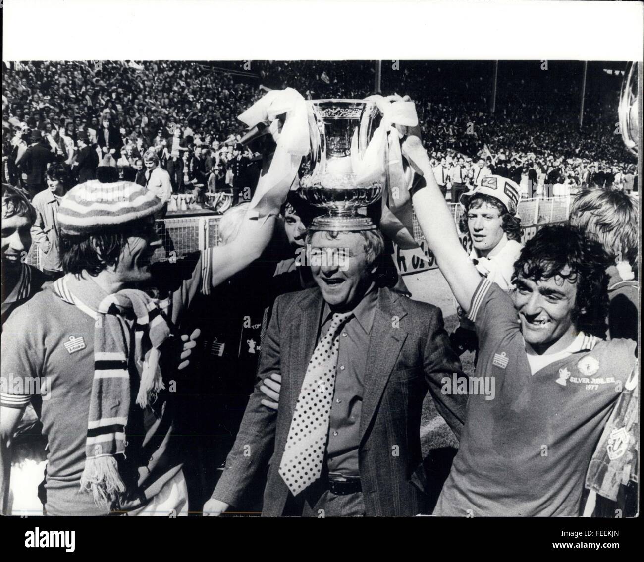 1973 - Manchester United Win The F.A. Cup Final Beating Liverpool By 2-1: At Wembley last Saturday Manchester United beat Liverpool by two goals to one in the Final of the F.A. Cup. For their manager Tommy Docherty this was his first Wembley success over the past 20 years, as a player and as a manager he had never won at Wembley, United were the esten finalists last year, when beaten by Southampton 1-0, so this year was Tommy's finest hour. Photo Shows: Tommy Docherty with the F.A. Cup on his head with the help of Goalscorer Stuart Pearson, left and Lou Macari as they do a lap of honour aroun Stock Photo