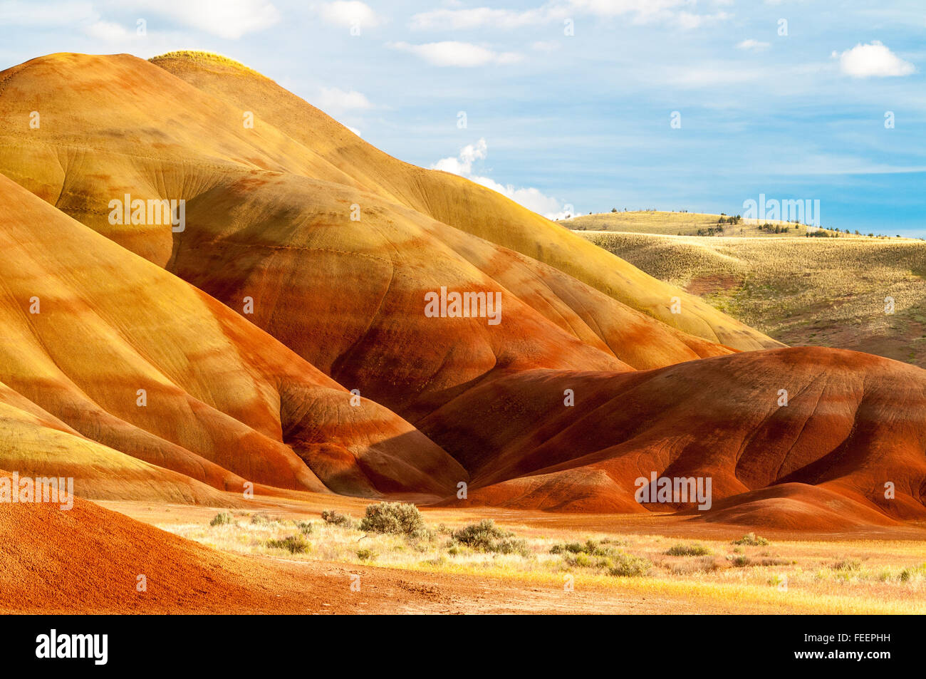 The afternoon sky above the colorful Painted Hills. Oregon, USA. Stock Photo