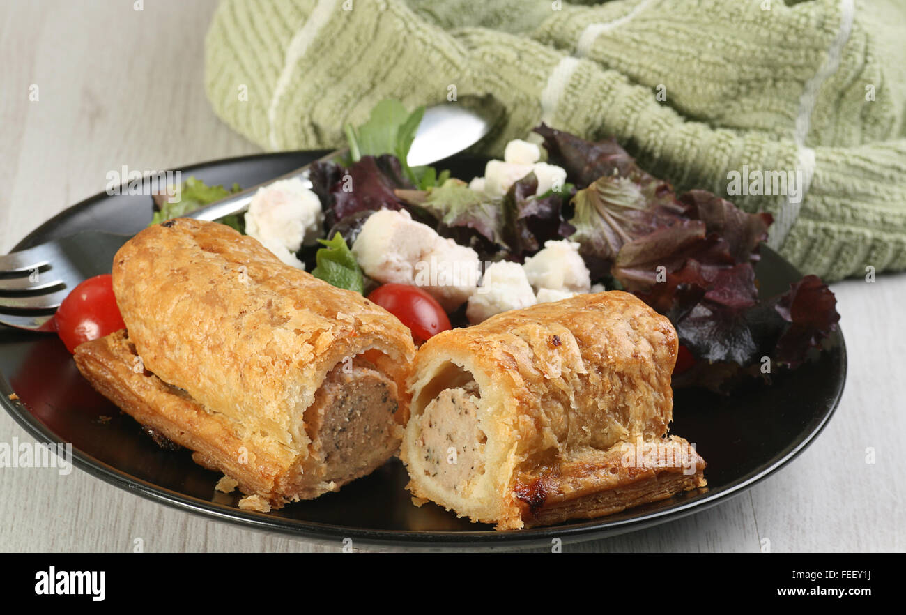 food halved sausage roll with green leaf salad Stock Photo Alamy