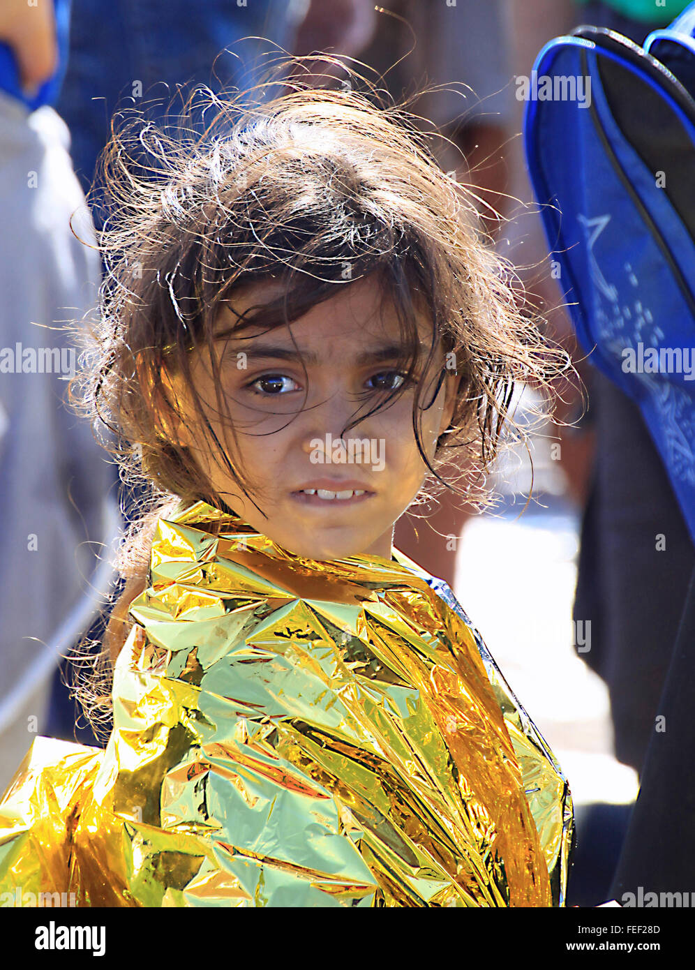 Young Syrian girl refugees refugee wrapped in a survival blanket after ...