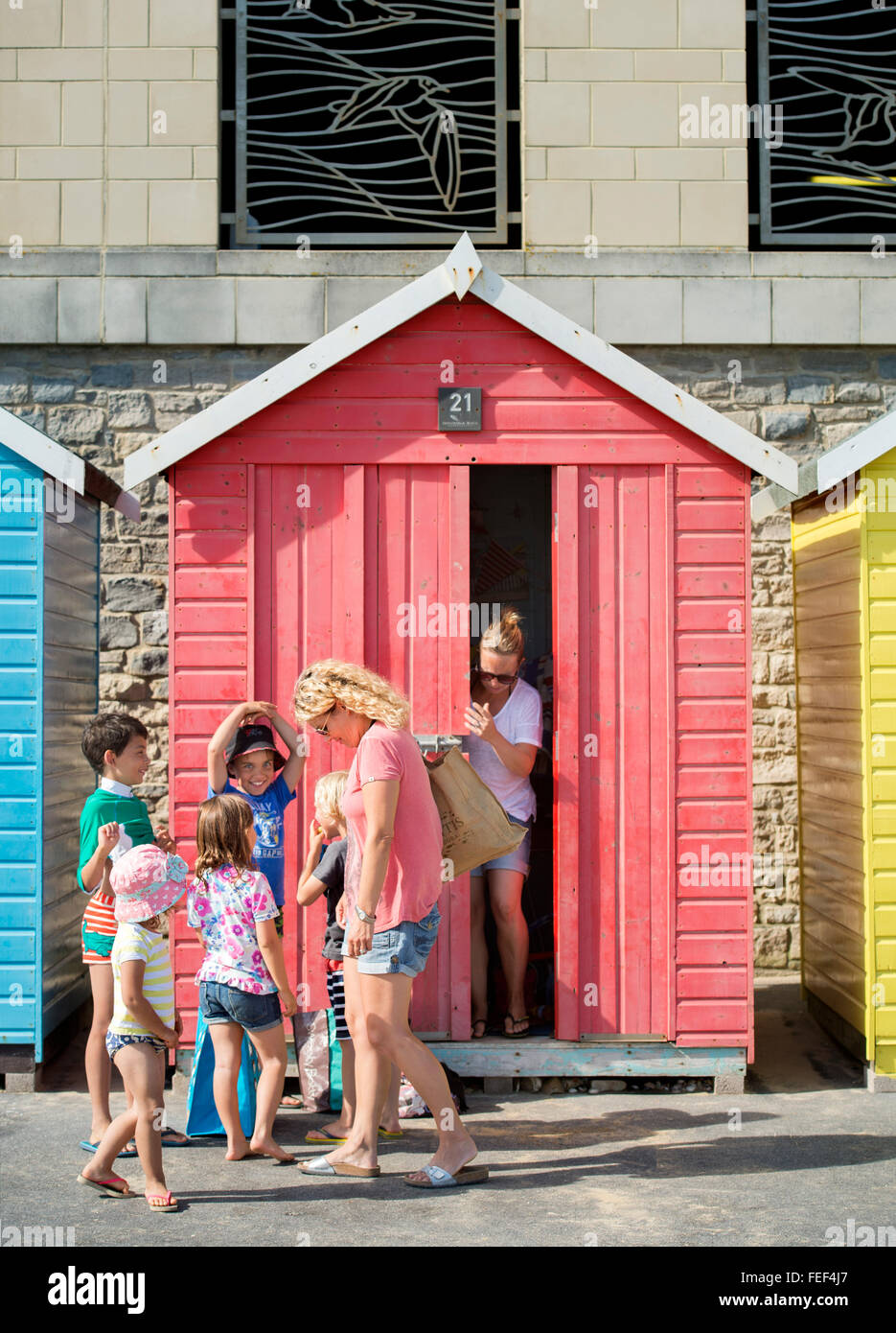 Holidaymakers and beach huts on Beach, Bournemouth UK Stock