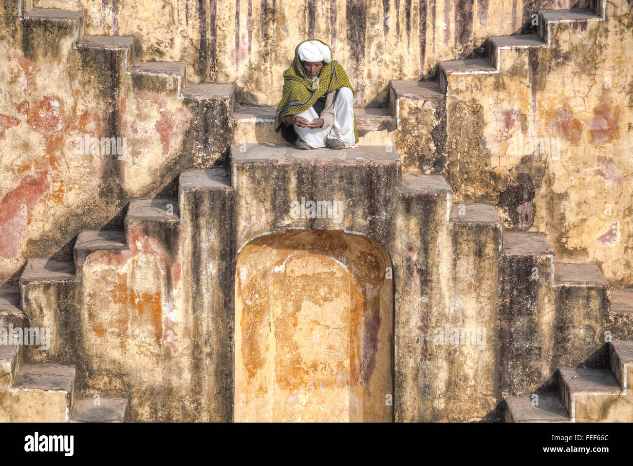 a man sitting in a stepwell in Jaipur, Rajasthan, India, South Asia Stock Photo