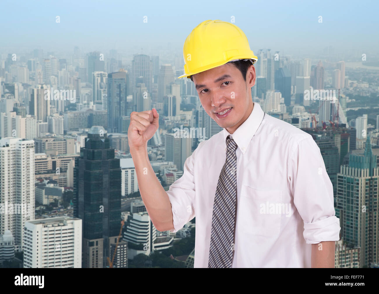 Happy engineer celebrating with arm raised, concept of successful, city ...