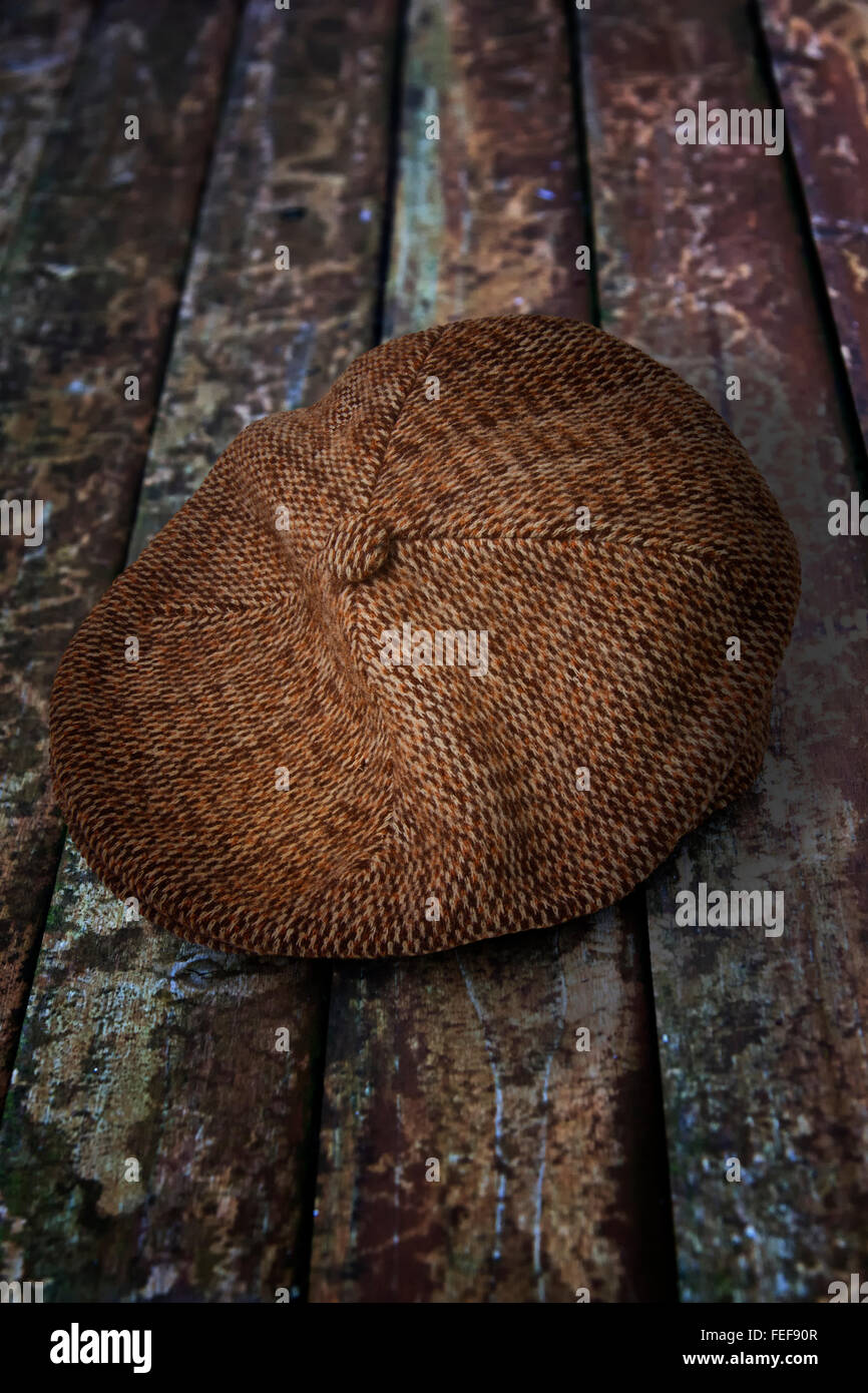 Cloth or flat cap on a wooden background Stock Photo