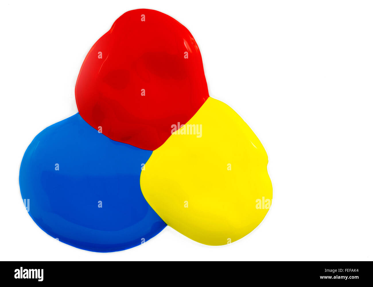 Three colors of poster paint Red blue and yellow on a white background Stock Photo