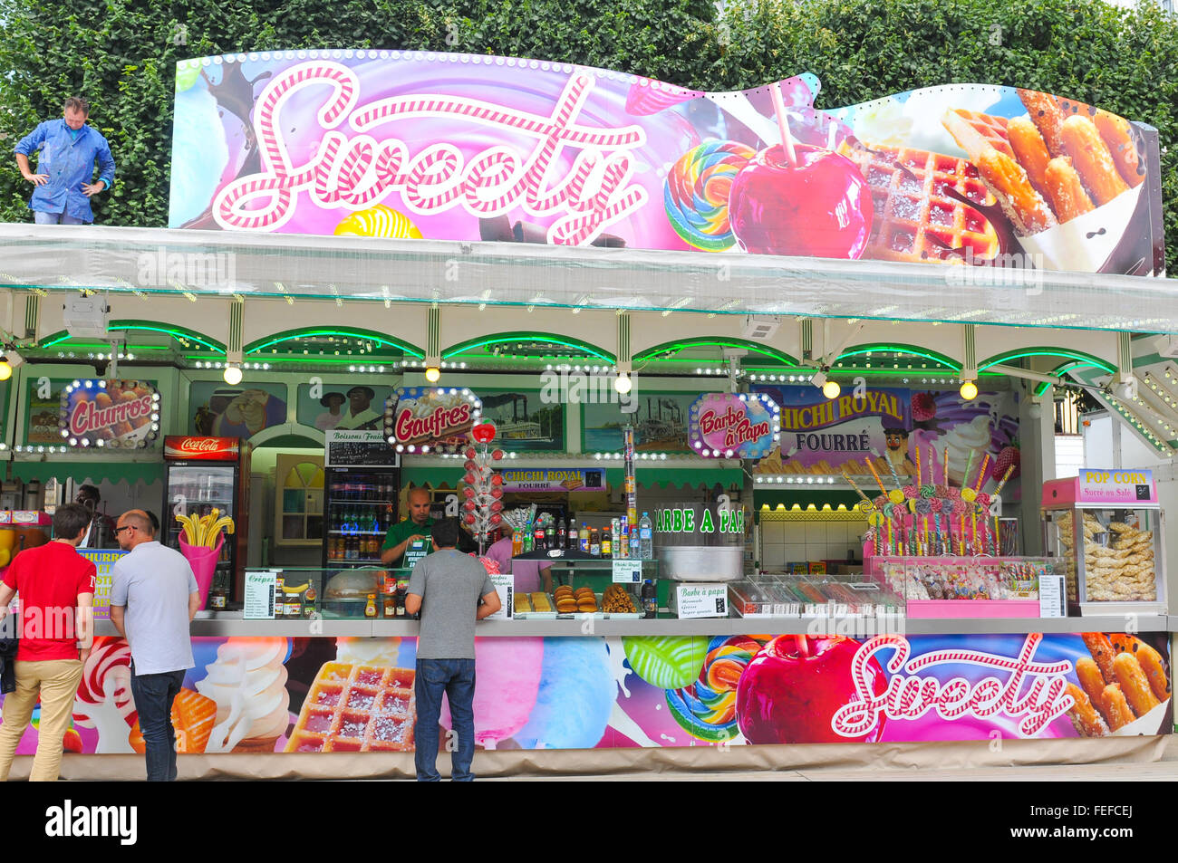 Paris, France - July 9, 2015: Tourists buy confectionery products at sweets shop in amusement park in Paris Stock Photo