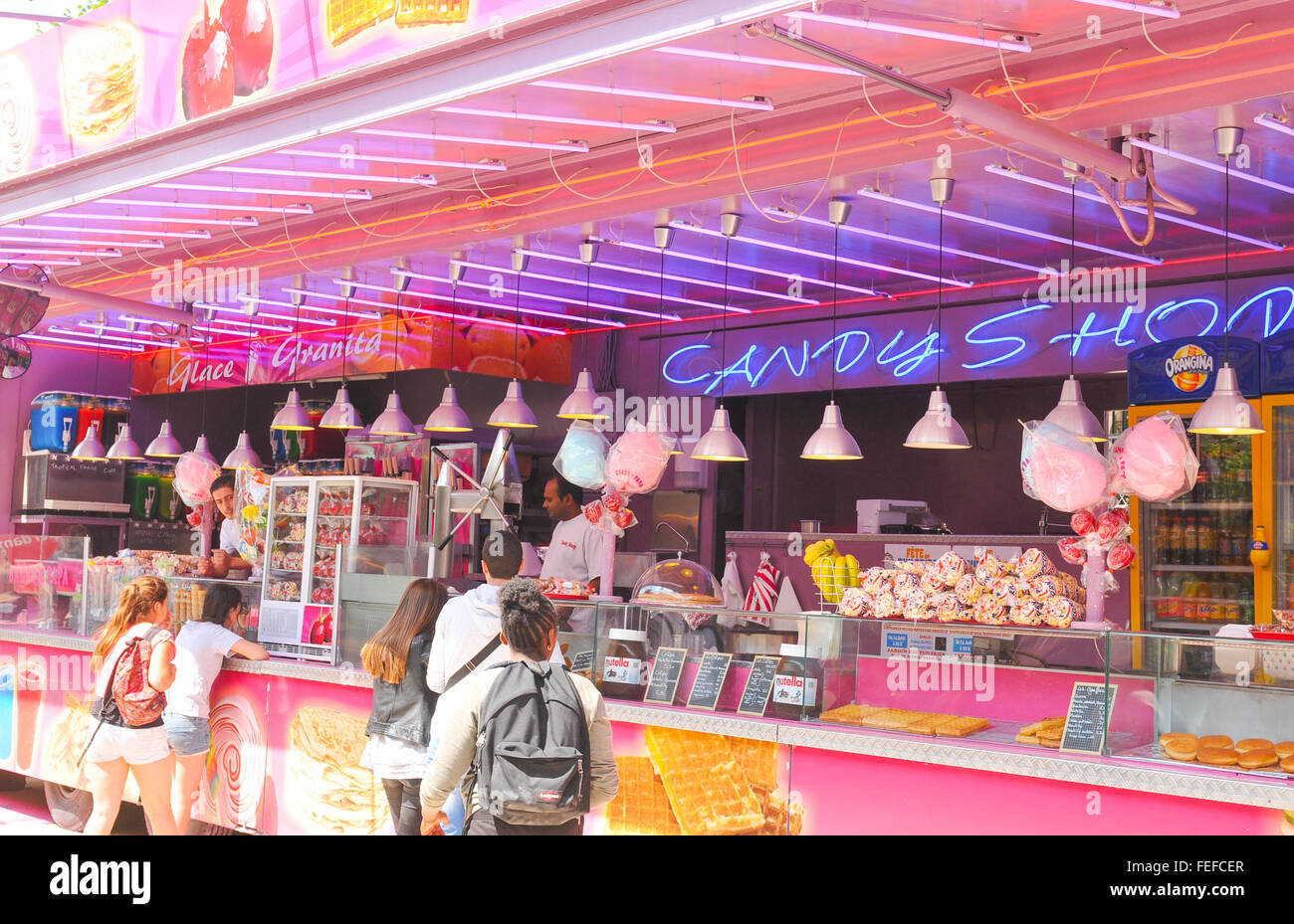 Paris, France - July 9, 2015: Tourists buy confectionery products at sweets shop in amusement park in Paris Stock Photo