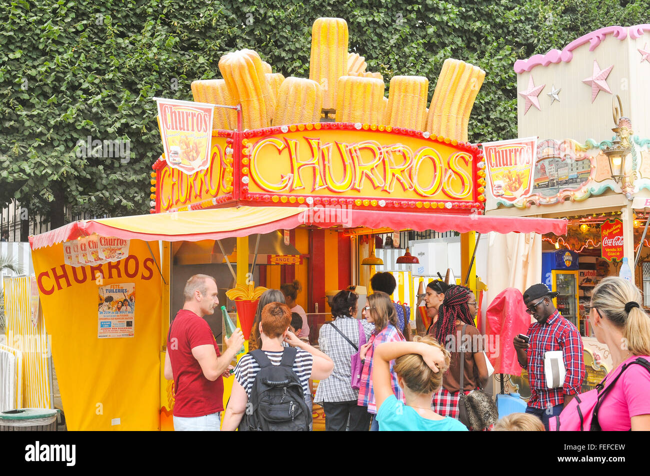 Paris, France - July 9, 2015: Tourists buy traditional churros at kiosk in Jardin des Tuileries, Paris Stock Photo