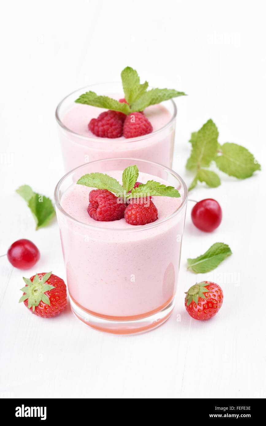 Raspberry smoothie decorated with mint in glass Stock Photo