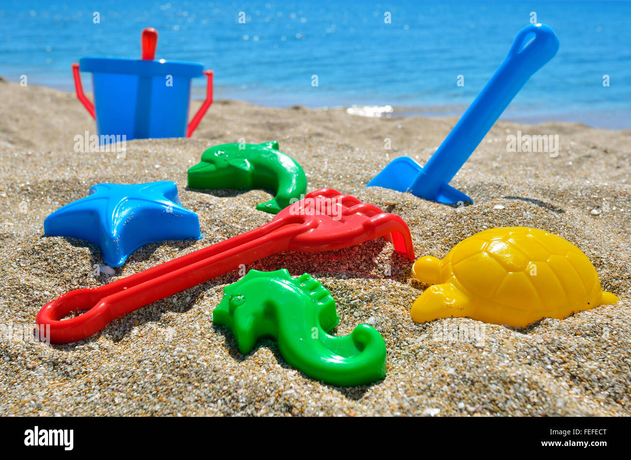 Baby beach toys on the sand against the blue sea Stock Photo Alamy