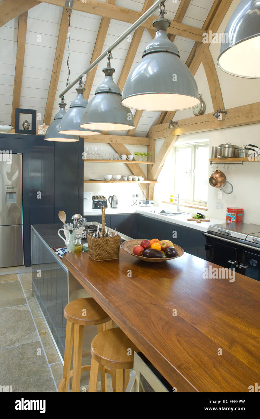 detail of modern kitchen, stools, downlighters and natural oak ceiling. Stock Photo
