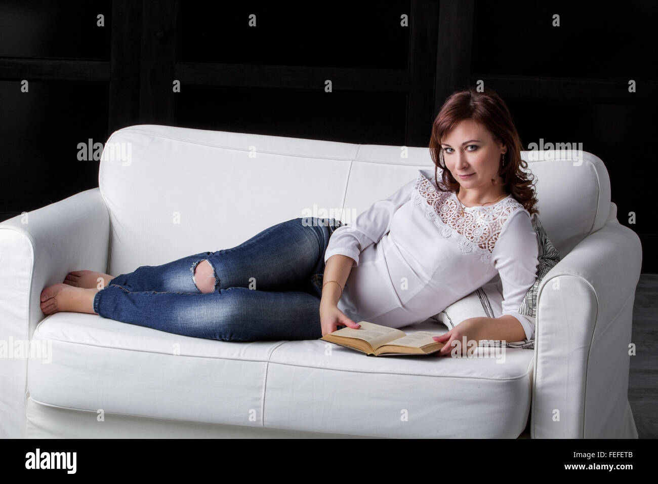 Girl lying on sofa hi-res stock photography and images - Alamy