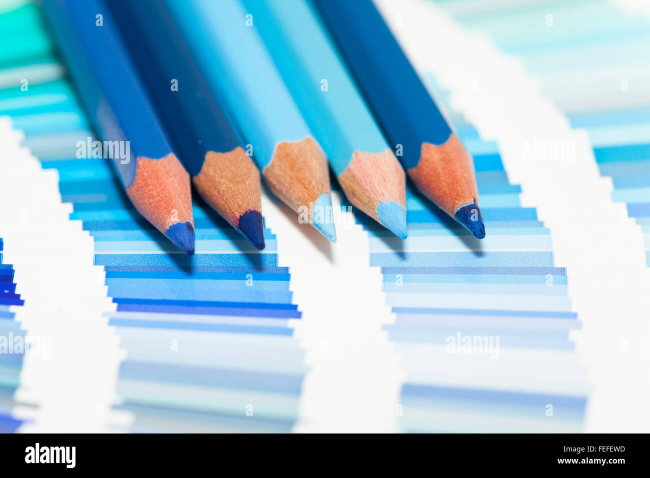 blue colored pencils and color chart of all colors Stock Photo - Alamy