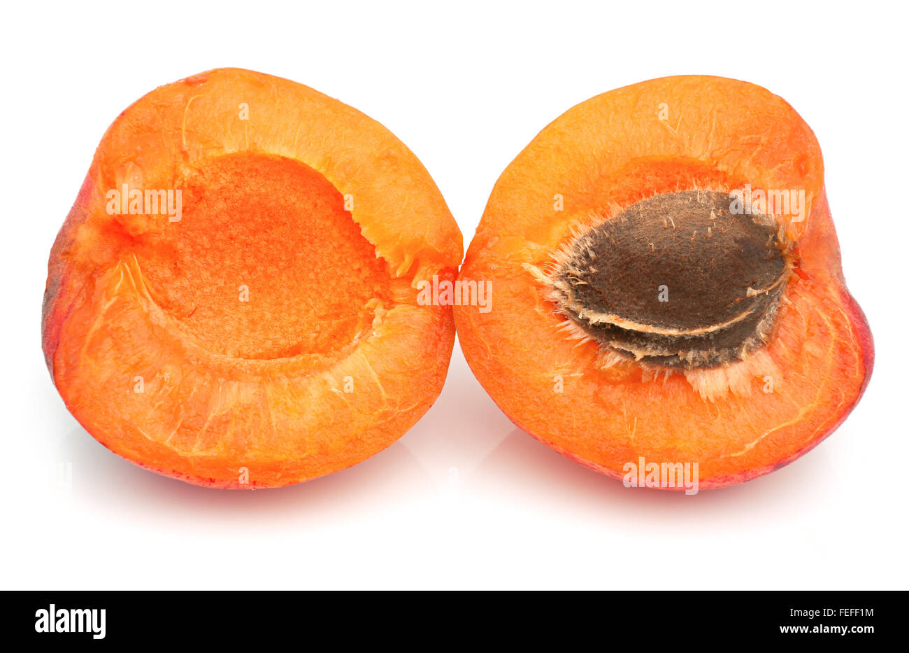 Ripe apricot with a pit on a white background Stock Photo - Alamy